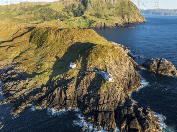Aerial view of Krakenes Fyr lighthouse, lighthouse located on steep cliff, norwegian coast north of Maloy, Vestland, Norway, Europe