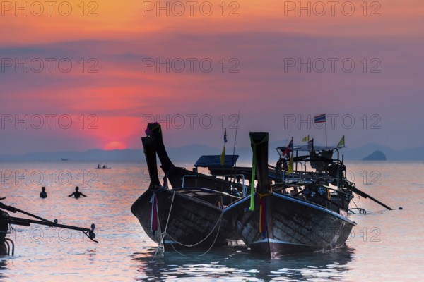 Longtail boat at sunset at Railay beach, evening mood, sun, evening, boat, sea, seascape, cloud, red sun, romantic, ocean, nature, beach holiday, beach holiday, travel, holiday, tourism, calm, chilly, bay, bathing bay, paradise, paradisiacal, exotic, heat, warm, climate, tropical, tropical, seascape, evening sky, silhouette, dusk, swimming, bathing, sky, Krabi, Thailand, Asia