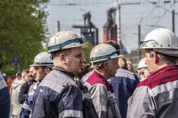 Steelworkers at a demonstration in front of the headquarters of ThyssenKrupp Steel Europe in Duisburg, against massive job cuts, after the participation of a foreign investor in the group, in the background the blast furnaces 8 and 9, Duisburg North Rhine-Westphalia, Germany, Europe
