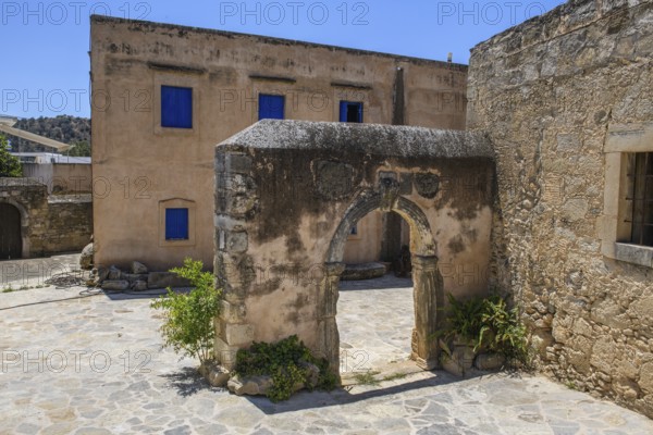 View of old historical Tor tor behind building with blue shutters of Ethnological Museum, Vori, Crete, Greece, Europe