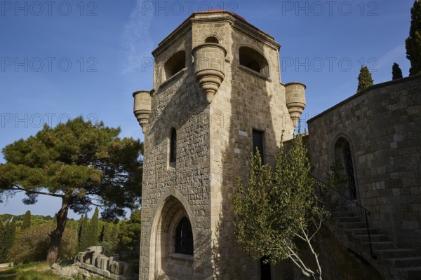 St John's Church, Historic stone tower with windows and stairs, surrounded by trees under a clear blue sky, Filerimos, hill not far from Rhodes town, Ancient State of Ialyssos, Rhodes, Dodecanese, Greek Islands, Greece, Europe