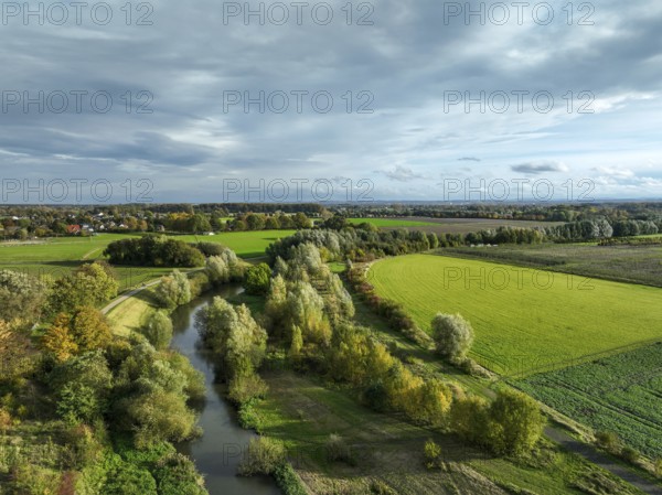 Bergkamen, Ruhr area, North Rhine-Westphalia, Germany, autumn landscape on the Seseke. The renaturalised Seseke, a tributary of the Lippe, has been transformed into a near-natural watercourse, flood protection and biodiversity through newly designed floodplains. Following the construction of a parallel sewer, the Seseke is now free of wastewater, having previously been an open, above-ground wastewater sewer, combined sewer with surface water and wastewater. Theme photo: EU Nature Conservation Act. The EU Nature Conservation Act obliges member states to implement measures to restore nature on at least 20 per cent of the EU's land and sea areas by 2030, Europe