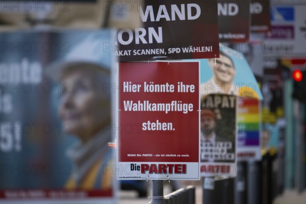 A poster with the inscription Here could be your election campaign wings. hangs between numerous election advertising posters for the Bundestag election on 23 February 2025, Mainufer, Frankfurt am Main, Hesse, Germany, Europe