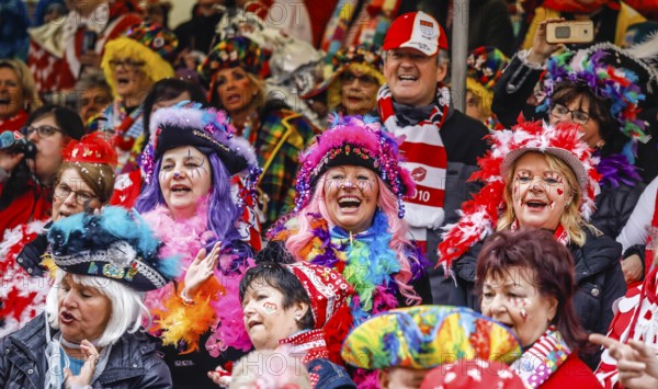 Colourfully costumed carnivalists celebrate carnival in Cologne, on Weiberfastnacht the street carnival is traditionally opened on the Alter Markt, which then reaches its climax on Rosenmontag, Cologne, Rhineland, North Rhine-Westphalia, Germany, Europe