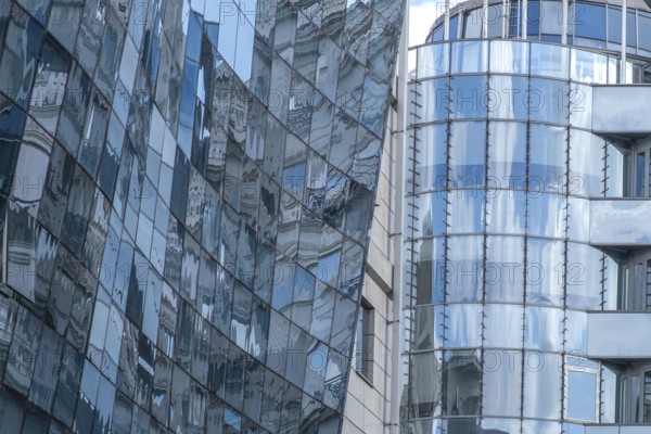 Reflective glass facades of modern office buildings with curved shapes and urban ambience, Skopje, North Macedonia, Balkans