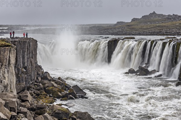 People standing in front of a waterfall at a river, cascades, spray, rapids, summer, foggy, Selfoss, North Iceland, Iceland, Europe