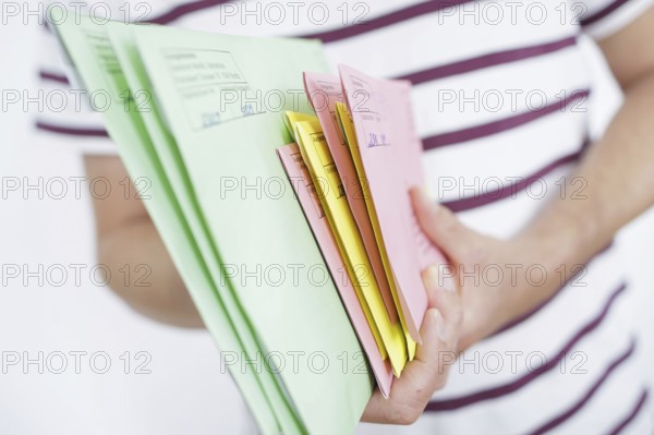 A man holds postal voting documents for the European elections, district council elections and municipal council elections in Brandenburg. Berlin, 04.06.2024