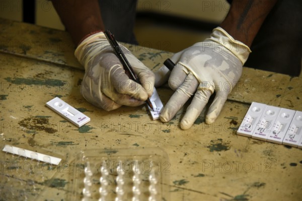 A health worker working before Covid-19 Rapid Antigen Testing (RAT), at a Swab collection centre ahead of durga puja festival, in Guwahati, India on 21 October 2020. A cumulative total of 9, 72, 00, 379 samples have been tested up to October 20. According to Johns Hopkins University, which has been compiling COVID-19 data from all over the world, India's death toll is the third-worst