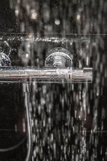 Shower, fitting, temperature control, temperature control of the shower water