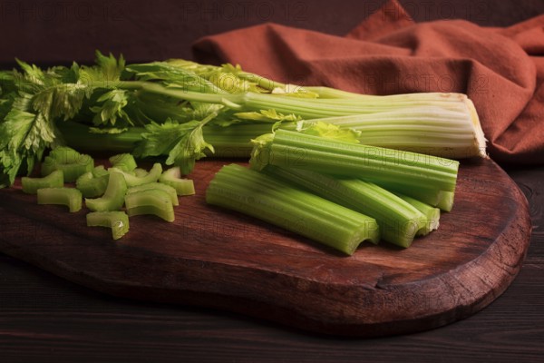 Fresh bunch of celery, top view, no people, on a dark background