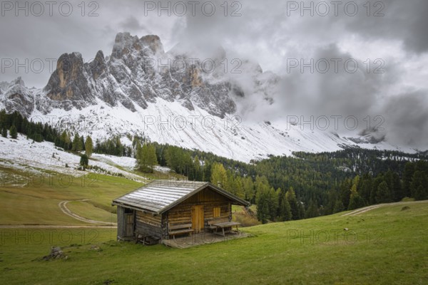View of a part of the Geisler group from the Gampenwiese, in the foreground an alpine hut, Dolomites, snow, Puez-Geisler nature park Park, St. Magdalena, Funes, Villnößtal, South Tyrol, Italy, Europe