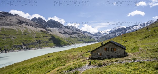 Alpine hut on a blue mountain lake, Lac des Dix reservoir, behind mountain peak Mont Blanc de Cheilon, Hérménence, Valais Alps, Valais, Switzerland, Europe