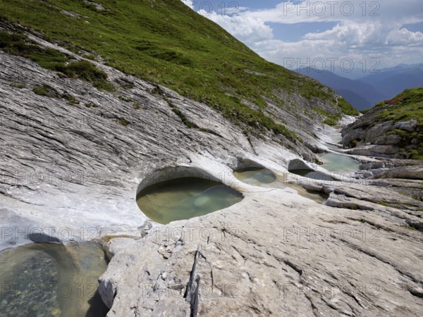 Glacier mill with glacier pots on the Trinser Alp Mora, Trin, Canton Graubünden, Switzerland, Europe