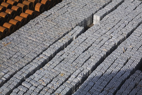 Top view of aluminium ingots and coils of flat rolled steel waiting for shipment at a terminal in the port of Salerno, Italy, Europe
