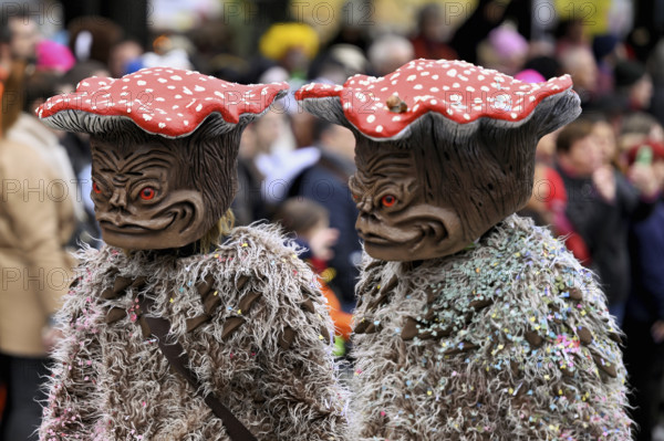 Two people masked as toadstools at the carnival parade of the Wey guild on Rose Monday, Güdismäntig, Lucerne Carnival 2024, Lucerne, Switzerland, Europe