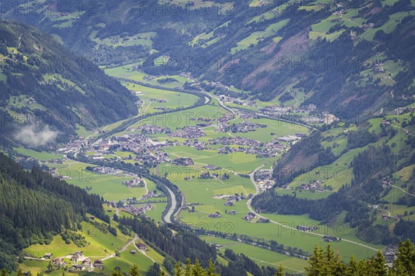 Green valley with village and river in the Alps, surrounded by mountains, Mayrhofen, Zillertal. Austria