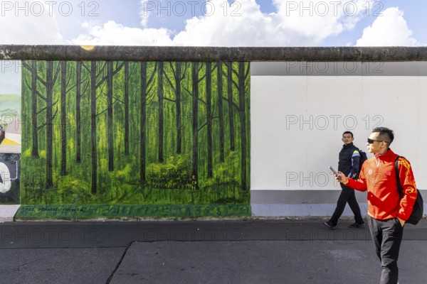 East Side Gallery. Remnant of the Berlin Wall, designed by artists. Landmark and city view Berlin, Germany, Europe