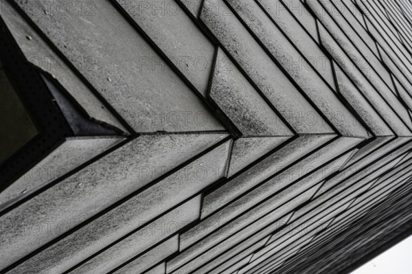 Close-up of an architectural façade with geometric design in grey tones