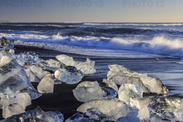 Ice floes on the beach, waves, sea, sunny, morning light, winter, Diamond Beach, Breidamerkursandur, Jökulsarlon, Iceland, Europe