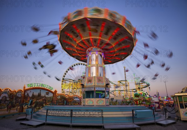 Chain carousel, Cannstatter Wellenflug, Ferris wheel, high ride, rides, motion, motion effect, neon lights, Cannstatter Wasen, blue hour, funfair, spring festival, folk festival, Bad Cannstatt, Stuttgart, Baden-Württemberg, Germany, Europe