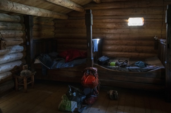 Rustic interior of a wooden hut with small beds and a rucksack, Olavsweg or Olavsleden, backdrop Kristin Lavranstochter film, Jørundgard Middelaldersenter, Olavsweg or Olavsleden, Sel municipality, Gudbrandsdalen, Norway, Europe