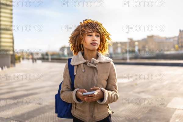 Beauty young latin woman using mobile phone to find a direction in the city