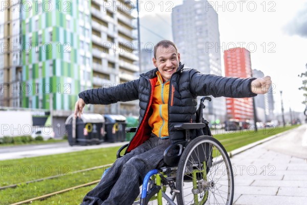 Young disabled man is joyfully navigating the city in his wheelchair, embracing independence and urban life