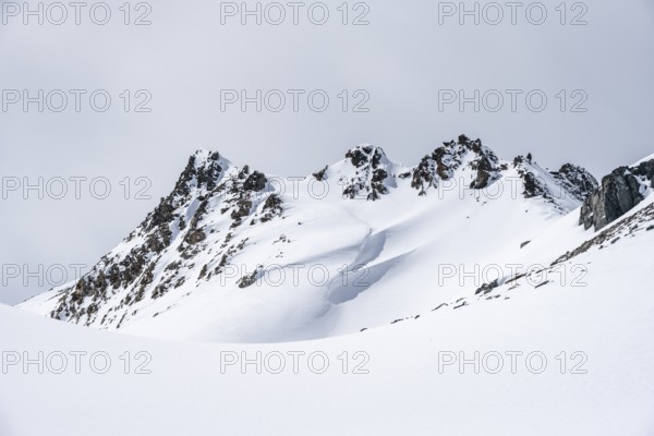 Minimalist winter landscape, white snow and dark mountains on the Scalettahorn, Graubünden, Switzerland, Europe