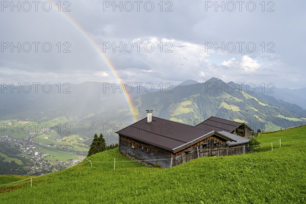 Alpine huts, view over the Brixen Valley with rainbow, Hochbrixen, Brixen im Thale, Kitzbühel Alps, Tyrol, Austria, Europe