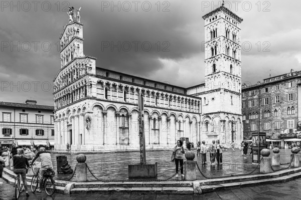 Dark rain clouds over the bell tower of the church of San Michele in Foro, and Piazza San Michele, historic city centre, black and white photo, Lucca, Tuscany, Italy, Europe