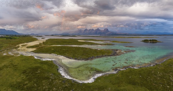 View of mountain range Seven Sisters from Herøy island, light mood with rainbow, Helgeland coast, Nordland, Norway, Europe