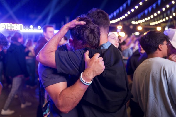 A fan of the England team is comforted at the Adidas fan zone at the Bundestag after the final match between Spain and England at the European Football Championship, Berlin, 14 July 2024