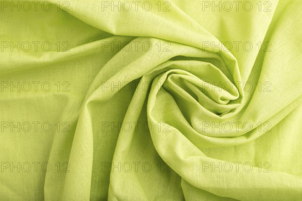 Fragment of green linen tissue. Top view, flat lay, natural textile background and texture. wave concept, abstract, spiral form