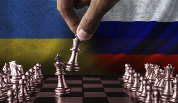 Russia vs Ukraine flag concept on chessboard. Political tension between Russia and Ukraine. Conflict between Russia and Ukraine over chess pieces