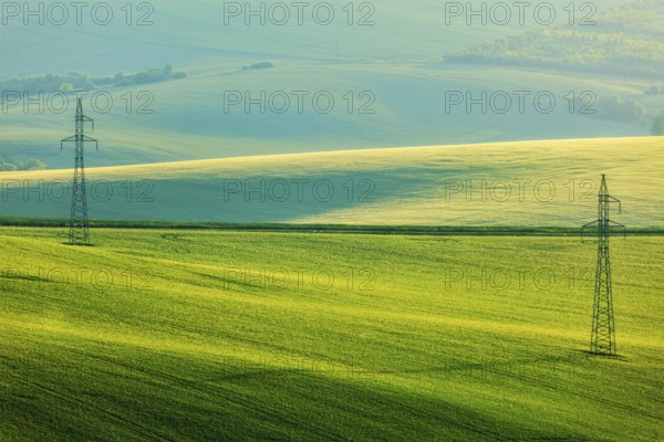 Moravian summer rolling landcsape with two power line tower. Moravia, Czech Republic, Europe