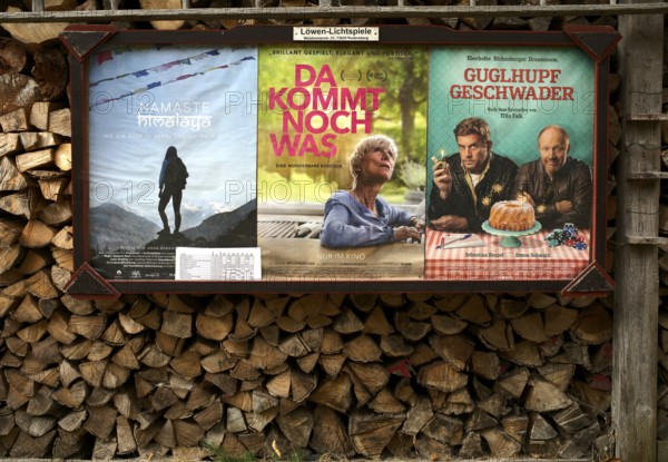 Old cinema advertisement hanging on wood pile, firewood, split, Swabian Forest, Baden-Württemberg, Germany, Europe