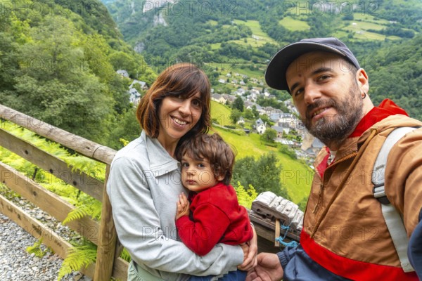 A family on a trail having fun in a Borce commune in the French Pyrenees and its beautiful mountains