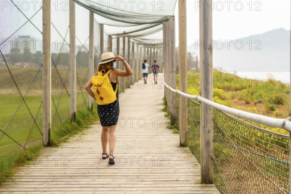 Summer vacation lifestyle. Young and adventurous girl enjoying the summer walking alone along the beach
