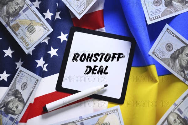 The flags of Ukraine and USA with dollar notes and plaque with the inscription raw materials deal, photomontage