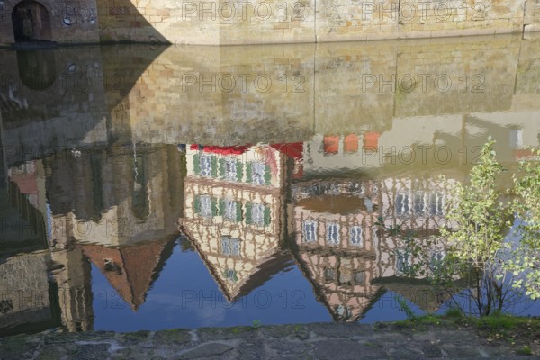Reflection of half-timbered houses and St John's Church, Kocher Valley, Kocher, Schwäbisch Hall, Hohenlohe, Heilbronn-Franken, Baden-Württemberg, Germany, Europe