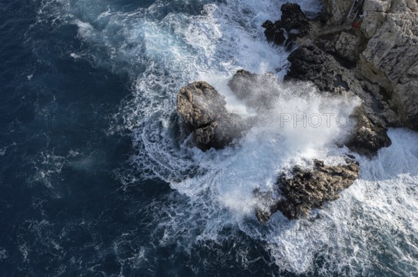 Drone aerial of rocky coast and stormy waves. Seascape windy waves. Stormy sea. Nature background. Cape Greko Cyprus