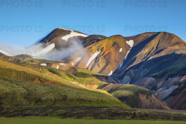 Early summer morning in the National Park Landmannalaugar, Iceland. In the hollows of rhyolitic mountain snow