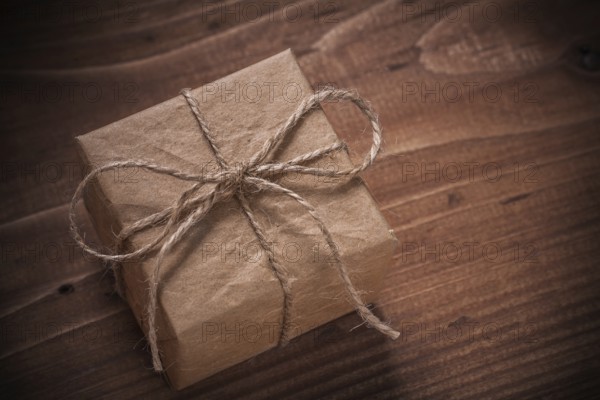 Classical vintage gift box with string bow on wooden board