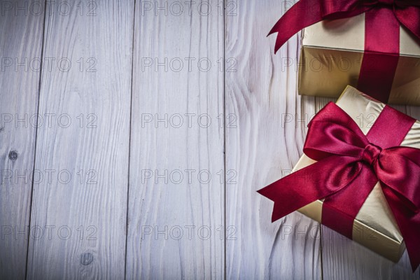 Gift boxes with ribbon on wooden board copy space holidays concept
