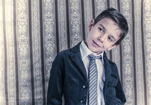 Boy in vintage black suit and tie