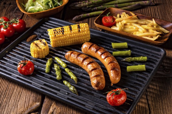 Grilled krakauer with french fries and green salad
