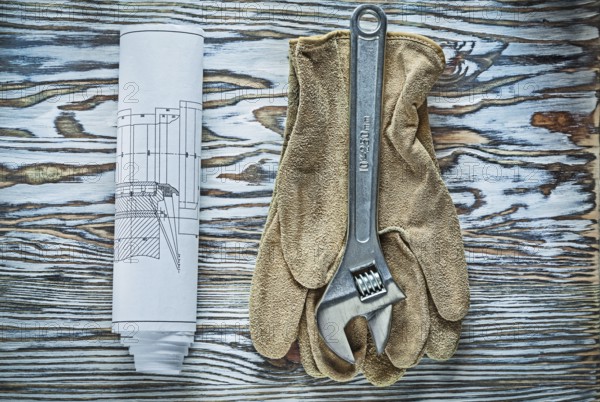 Adjustable spanner safety gloves construction plans on vintage wooden board