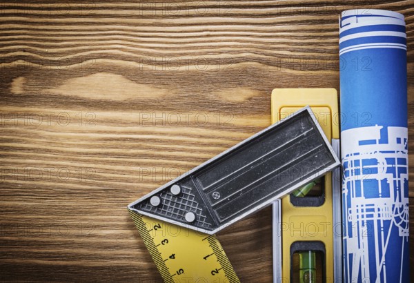 Blue construction drawing level try square on wooden board