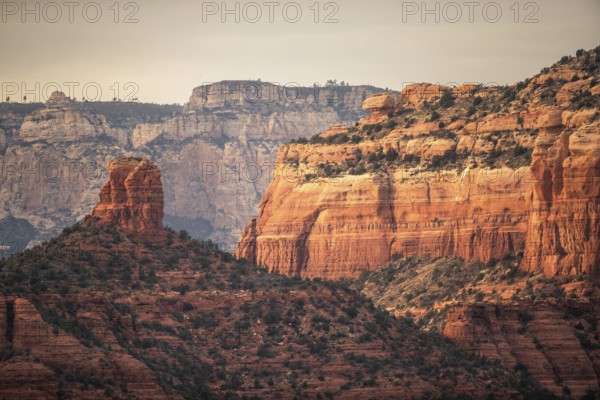 Majestic red rock formations and cliffs in a desert landscape under a clear sky in Sedona, Arizona, USA, North America