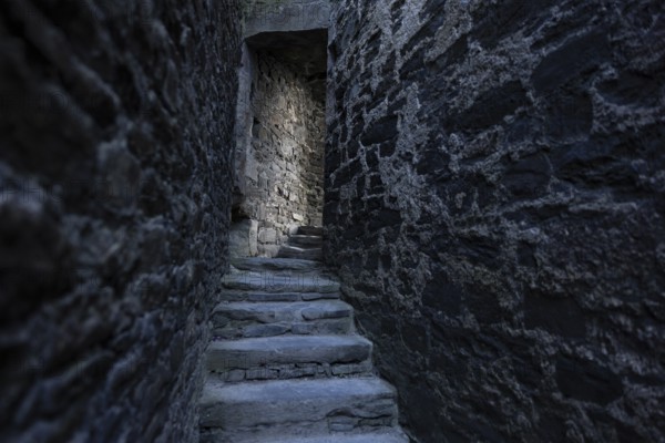 Conwy Castle, medieval stone staircase of the castle winds through narrow, dark and historic corridors, Conwy, Wales, United Kingdom, Europe